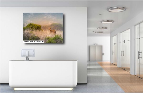 A bathroom with a painting of a cow in the background.