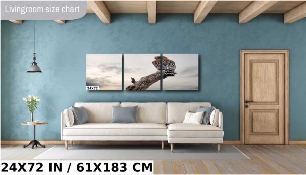 A giraffe is standing on the ground in front of a sky.