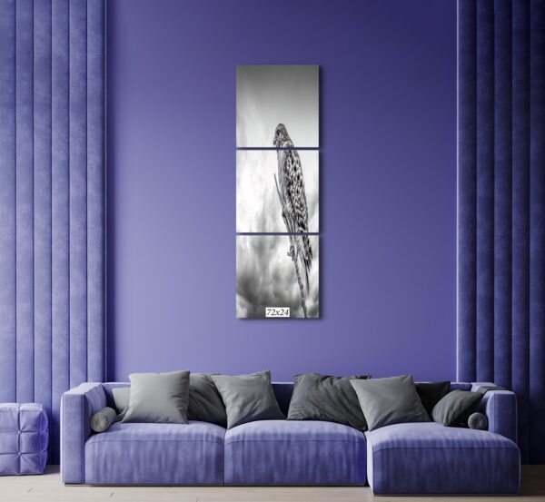 A purple room with a couch and wall hanging
