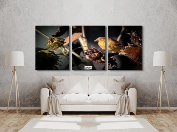 A living room with a couch and three paintings