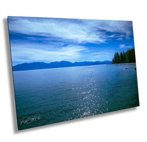 A picture of the ocean with mountains in the background.