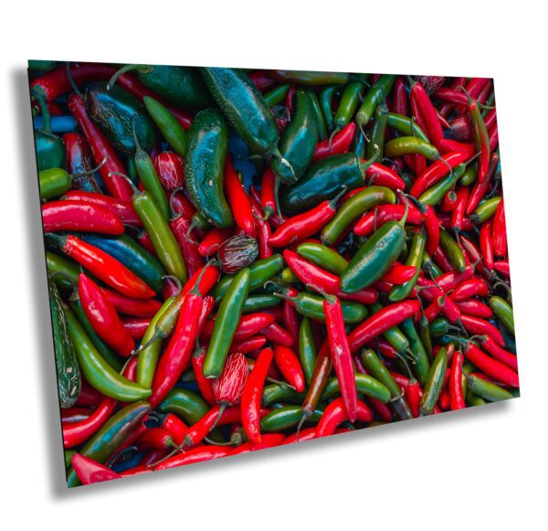A bunch of green and red peppers on display