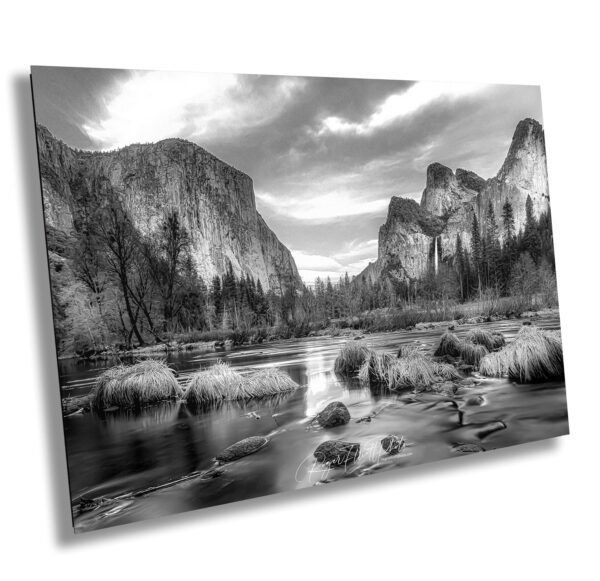 A black and white photo of mountains near water