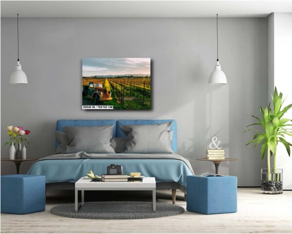 A bedroom with a blue bed and a painting on the wall