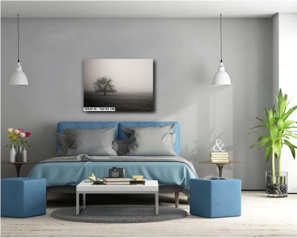 A bedroom with a bed, lamps and a painting.