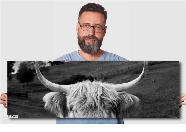A man is standing next to an image of a bull.