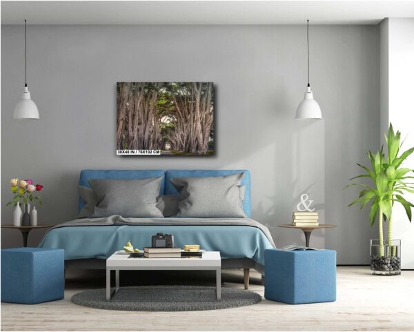 A bedroom with a bed, lamps and a painting.