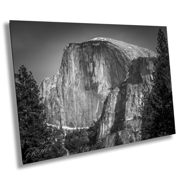 A black and white photo of the side of half dome.
