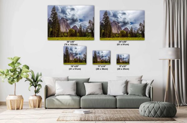 A living room with couch and pillows, and several sizes of pictures.