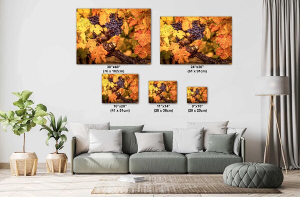 A couch with pillows and a painting of leaves.