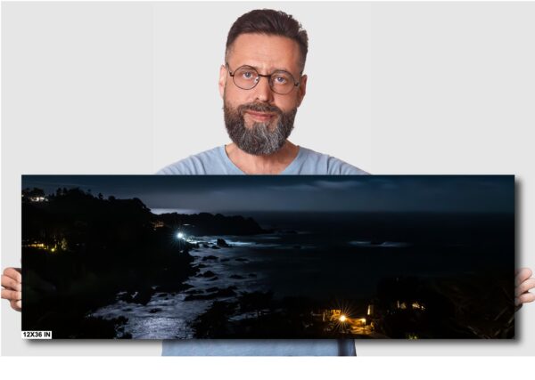 A man is looking at the camera with a dark sky in the background.
