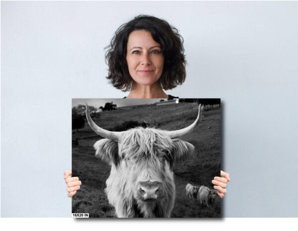 A woman holding up an animal picture.