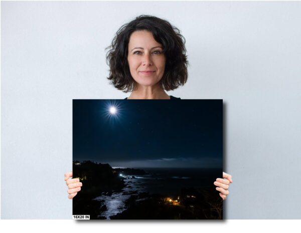 A woman holding up a picture of the moon
