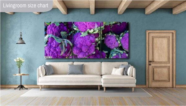 A living room with a couch and purple flowers