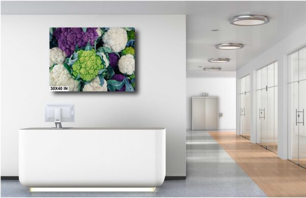 A white bathroom with a large picture of flowers.