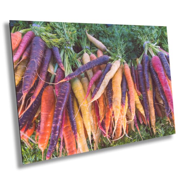 A bunch of carrots are hanging up in the grass