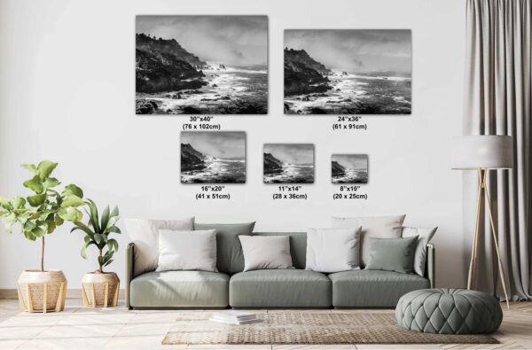 A living room with couch and pillows, and many different sizes of pictures.