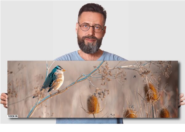 A man standing next to a painting of a bird.
