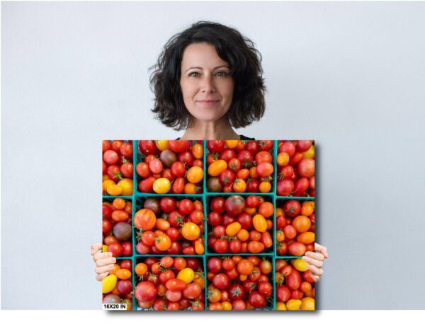 A woman holding up a box of tomatoes.