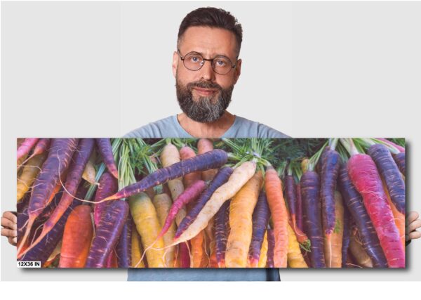 A man standing next to a bunch of carrots.