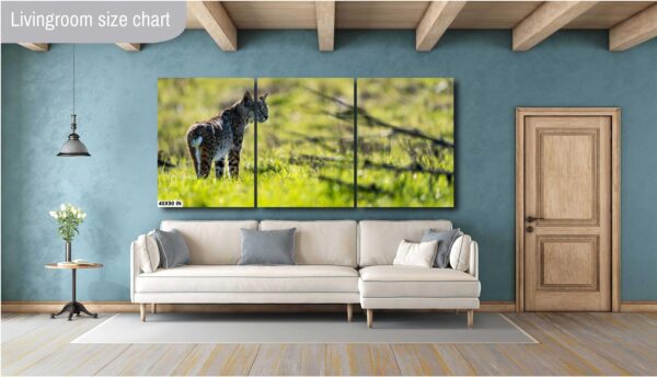 A large couch in front of a wall with a picture on it.