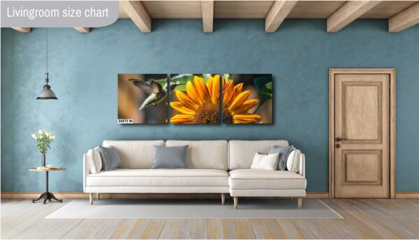 A couch and a wall with two paintings of flowers