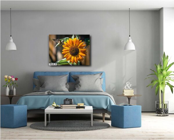 A bedroom with a blue bed and a yellow sunflower.