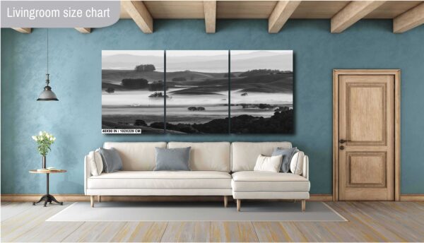 Black and white image of fog rolling over hills and a farmhouse in Sonoma County, California