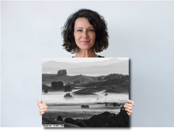 Black and white image of fog rolling over hills and a farmhouse in Sonoma County, California